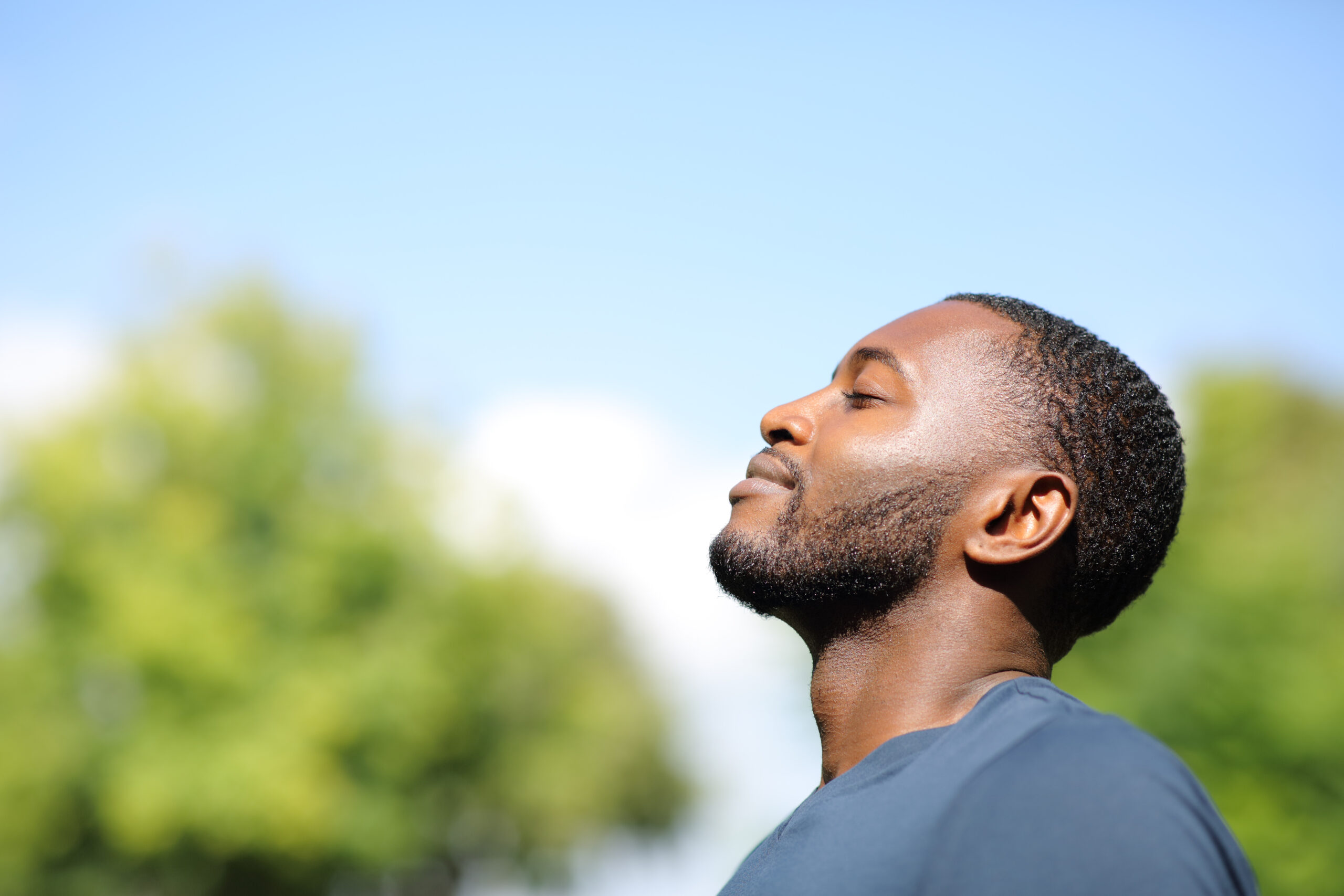 A man looks happy and relaxed in the sunshine