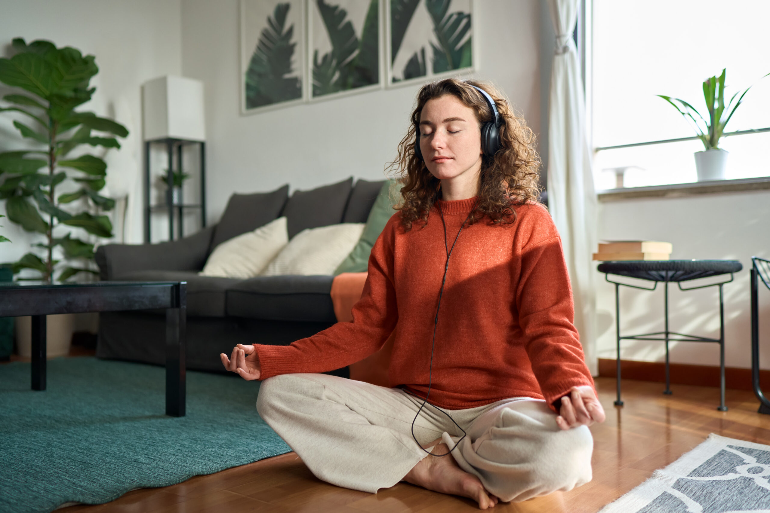 A young woman sits meditating